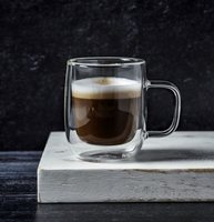 A shot of macchiato on wooden cutting board on black background