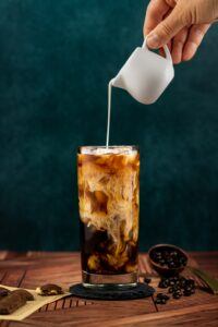 Iced Coffee With Milk Being Poured